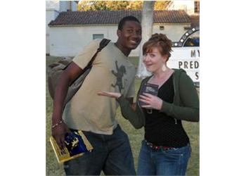 two people posing with a thumbs up