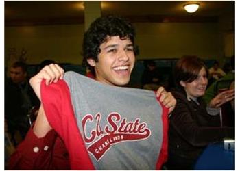 person holding up a 'cal state' shirt