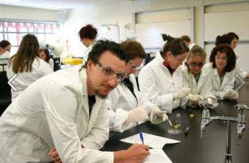 students in lab coats conducting experiments