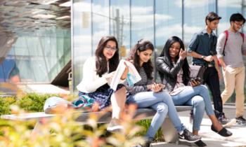 students sitting and walking outdoors at centennial college